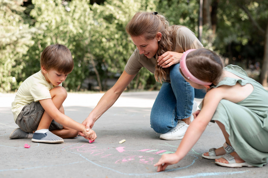full-shot-kids-teacher-drawing-ground (1).jpg